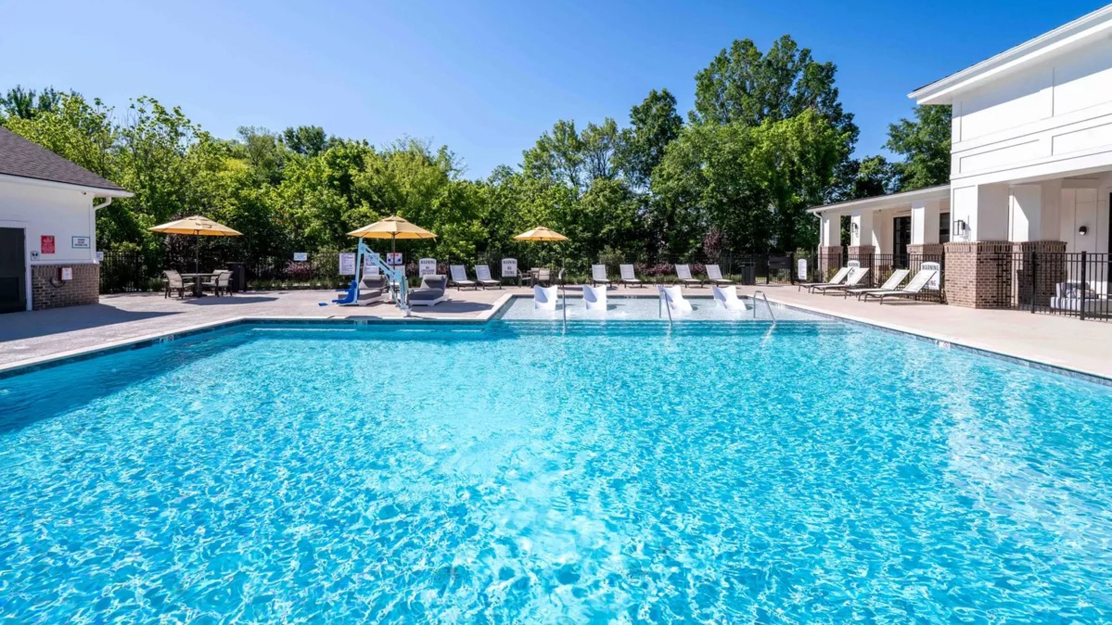 Hawthorne at Whitehall smiling young man relaxing at home and using tablet